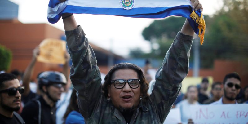 A man holds a Salvadoran flag during a protest against municipal and parliamentary elections results in San Salvador, El Salvador, March 6, 2018. REUTERS/Jose Cabezas