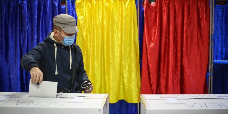 A man cassts his ballot at a polling station in Bucharest during the parliamentary elections on December 6, 2020. - Romanians will vote on Sunday December 6, 2020 in legislative elections in which the pro-European liberals in power are favored, despite a criticized management of the coronavirus pandemic and an economic crisis that threatens to continue. (Photo by Daniel MIHAILESCU / AFP) (Photo by DANIEL MIHAILESCU/AFP via Getty Images)