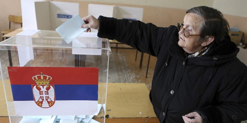 A woman casts her vote at a polling station during Serbian elections in Kosovo's town of Mitrovica March 16, 2014. Serbia's center-right Progressive Party bid to cement its grip on power for the next four years in a snap election on Sunday, promising an economic overhaul of the ex-Yugoslav republic as it embarks on talks to join the European Union. REUTERS/Bojan Slavkovic (KOSOVO - Tags: ELECTIONS POLITICS)